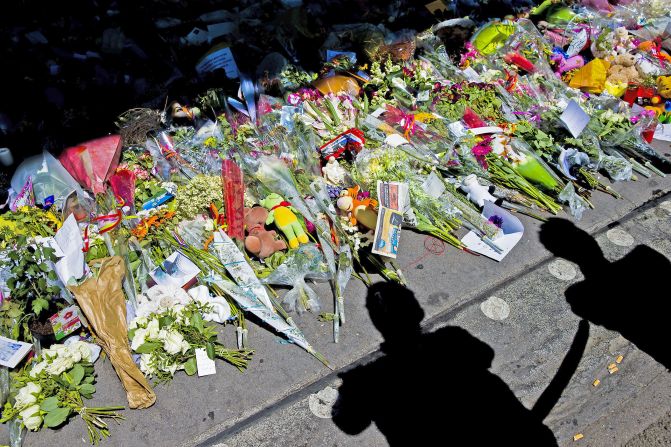 Flowers are placed at Schiphol airport as Dutch royals meet the planes with grieving relatives and representatives from the 11 countries that had citizens among the 298 MH17 victims.