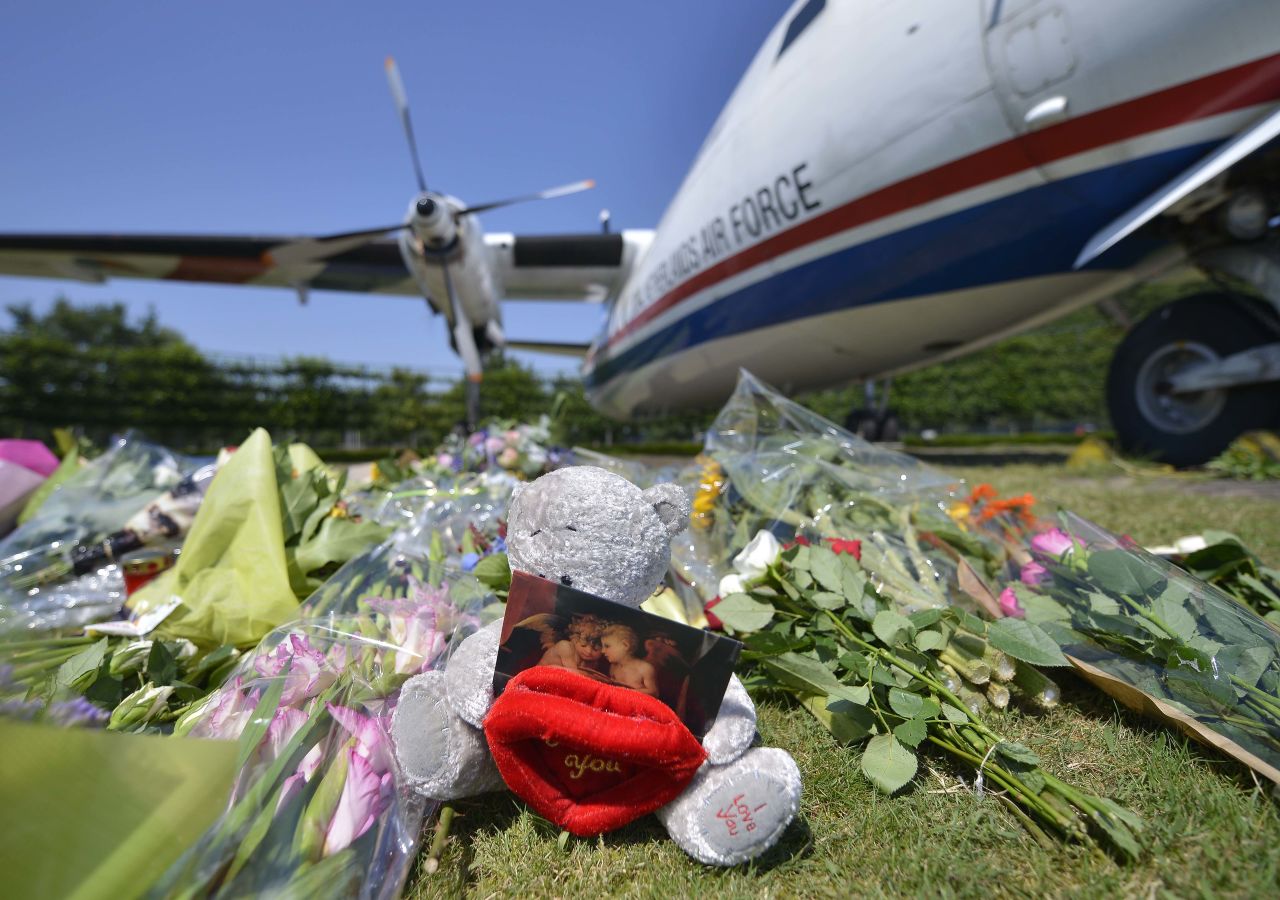 Eindhoven military air base, July 23, 2014: Flowers and a teddy bear are placed in front of a plane before a ceremony marking the return of the first bodies of passengers on board Malaysia Airlines Flight 17. The bodies will be taken to a military barracks in the city of Hilversum, where forensic experts will begin the task of identifying and returning them to relatives.