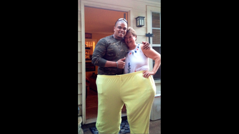 At her "200-pound" weight-loss party, Riser tries on a pair of old pants -- large enough for her and personal trainer Shaun Lloyd.