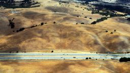 This picture taken from a helicopter shows a drought affected area near Los Altos Hills, California, on July 23. One of California's worst droughts in decades could cost the US state's farmers $1.7 billion, a recent study warned. 
