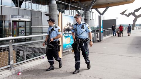 Armed police patrol outside the terminal at Oslo Airport on Thursday, July 24.