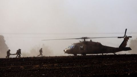 Israeli soldiers carry a wounded soldier to a helicopter near the Israel-Gaza border on July 24. 
