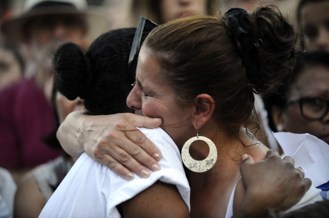 People react as they gather during a silent march in Amsterdam.