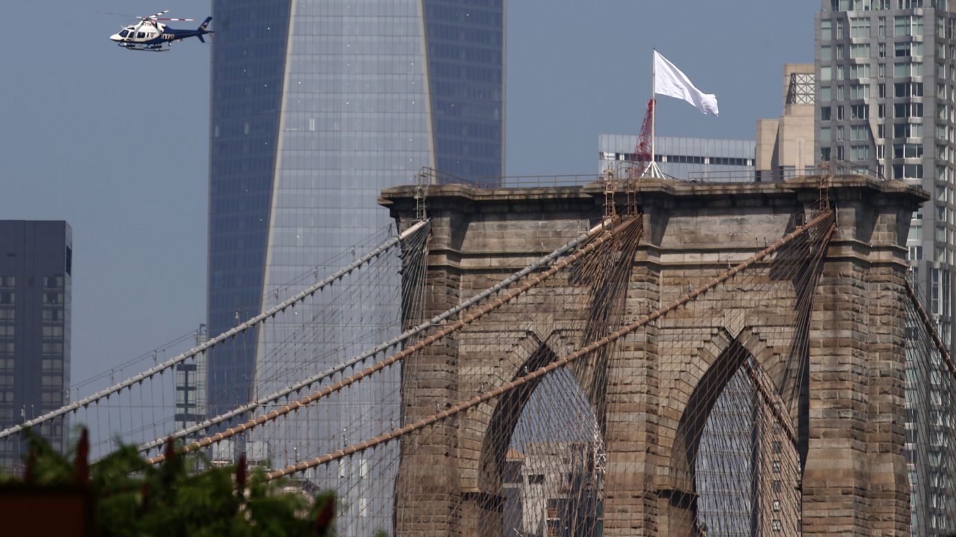 A New York Police Department helicopter flies over the Brooklyn Bridge on Tuesday, July 22. Police are trying to find out who removed the bridge's two American flags and <a href="http://www.cnn.com/2014/07/22/us/new-york-brooklyn-bridge-flags/index.html">replaced them with white flags</a> overnight.