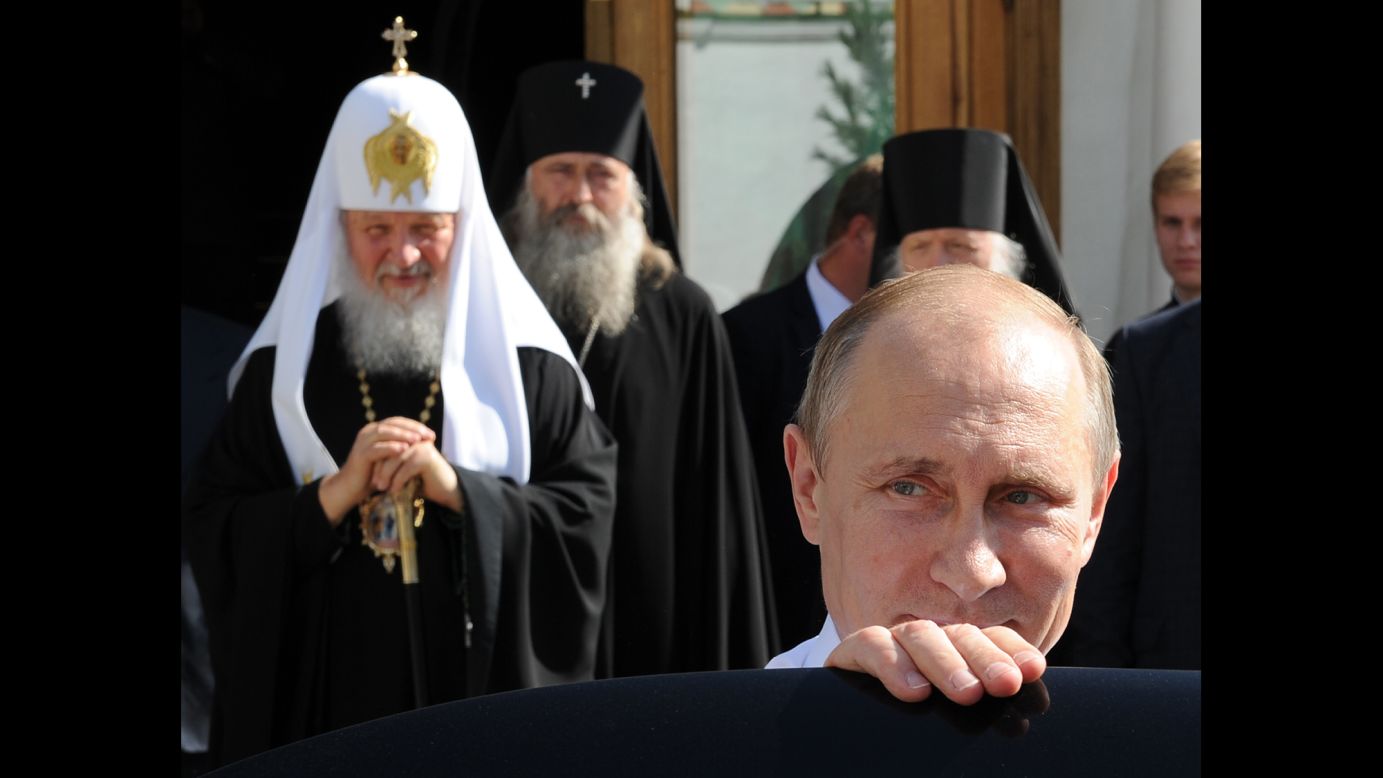 Russian President Vladimir Putin, front, leaves after meeting with Russian Orthodox Patriarch Kirill, left, on Friday, July 18, in Sergiyev Posad, Russia. Putin was attending celebrations for the 700th anniversary of St. Sergius of Radonezh.