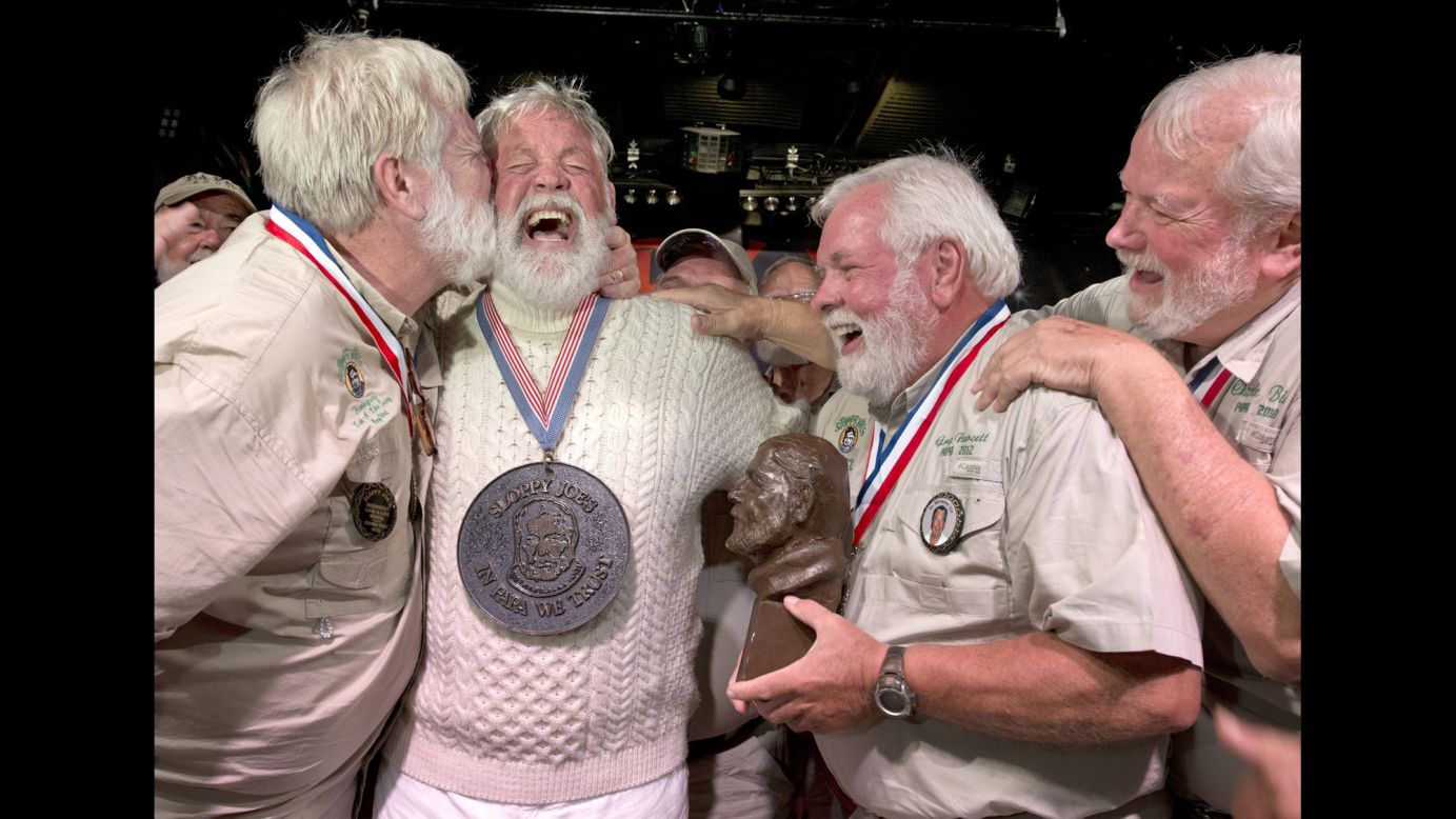 Wally Collins, second from left, is congratulated Saturday, July 19, after beating 130 other men in the annual Ernest Hemingway look-alike contest in Key West, Florida. The Pulitzer Prize-winning author lived in Key West during the 1930s and wrote some of his famous work there.