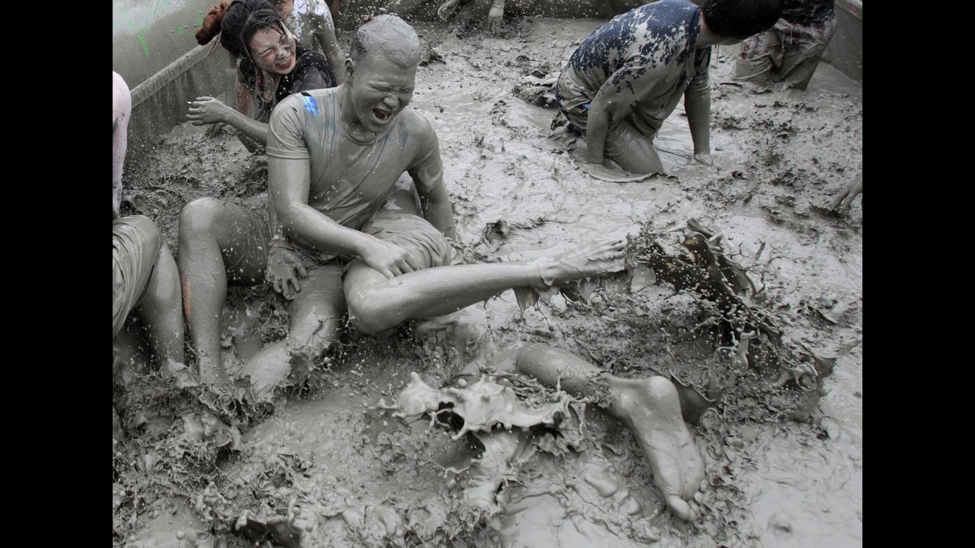 Participants play in a mud pool Friday, July 18, during the Boryeong Mud Festival in Boryeong, South Korea. The annual festival features mud wrestling and mud sliding.