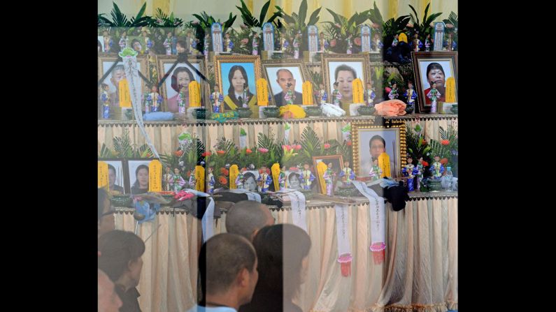 On July 24, relatives of passengers pray at an altar set up for the victims.