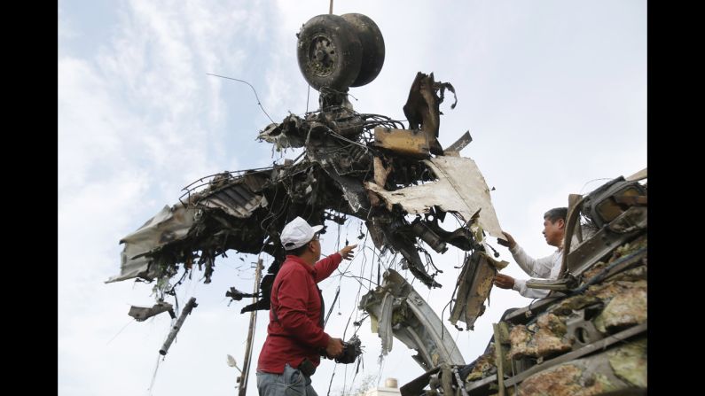 Emergency workers remove the wreckage on July 24.