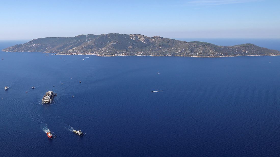 Tugboats tow the wreck of the Costa Concordia as it leaves Italy's Giglio Island on Wednesday, July 23. 
