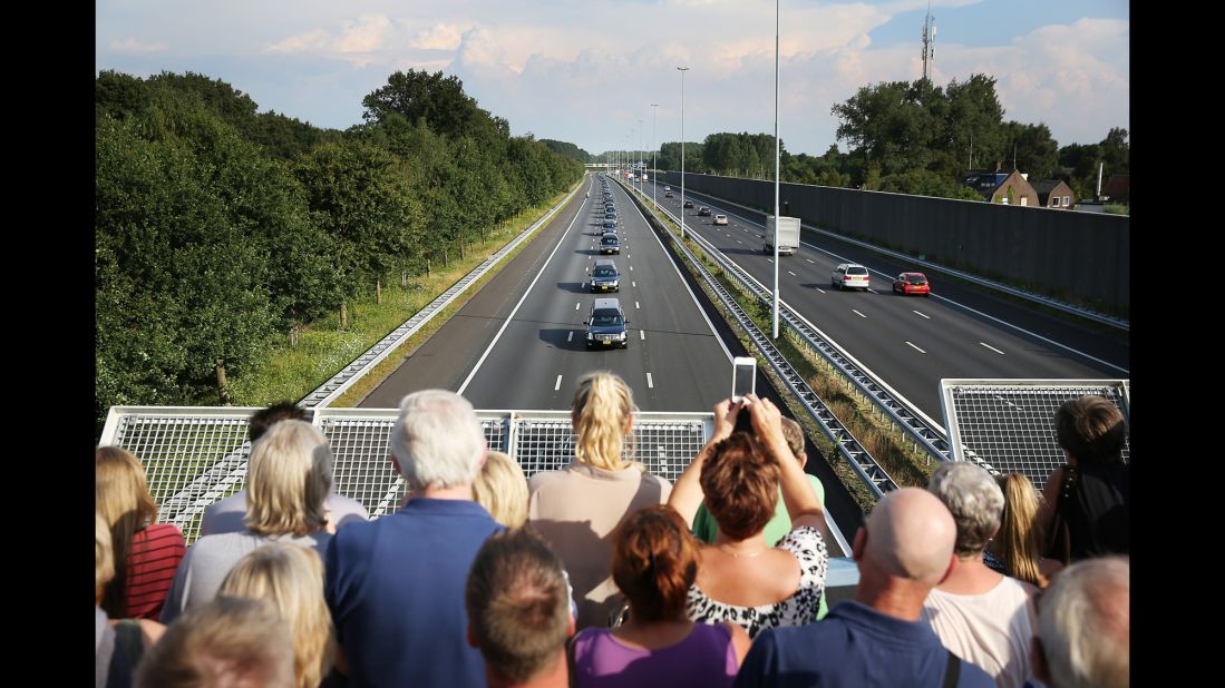 People watch from a bridge in Boxtel, Netherlands, as hearses carry victims to Hilversum, Netherlands, on Thursday, July 24.