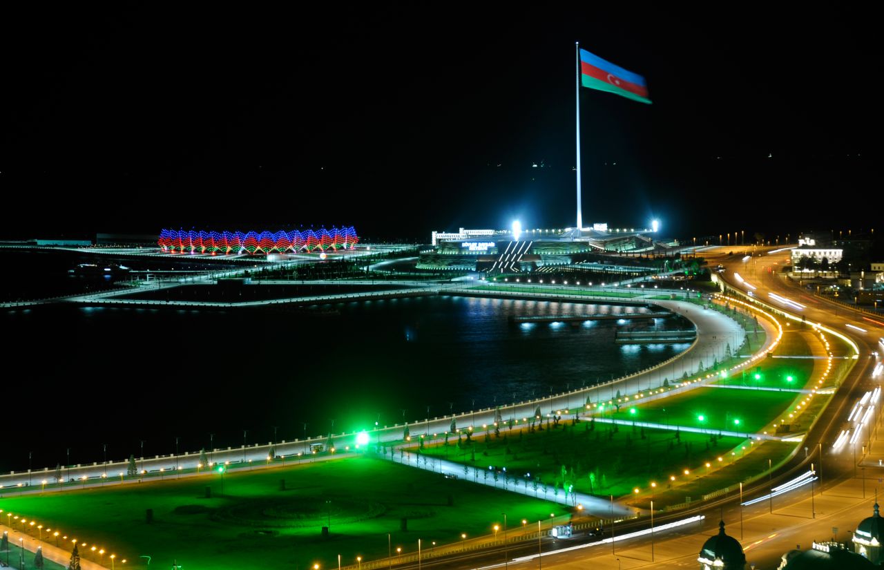 The flag of Azerbaijan blows in the wind above the country's capital city of Baku.