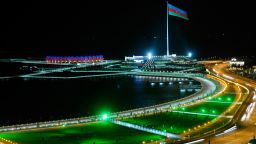 The flag of Azerbaijan blows in the wind above the country's capital city of Baku.
