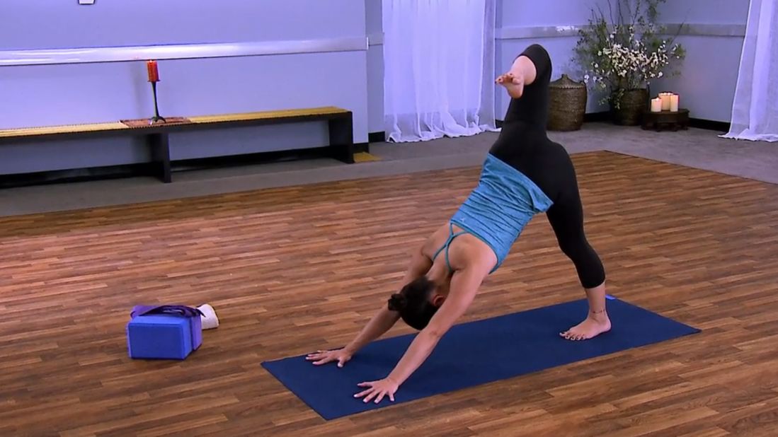<strong>Down Dog (Adho Mukha Svanasana):</strong> Inhale to a flat back and step back to<a href="http://dailyburn.com/life/fitness/yoga-poses-down-dog-video/?partner=cnn&mtype=5&sub_id=07282014_yogastress&utm_source=cnn&utm_medium=cnn&utm_campaign=07282014_yogastress&utm_content=07282014_yogastress" target="_blank" target="_blank"> downward dog</a>, holding for one minute. Let energy flow through your arms and out through the sit bones. Keep your neck long and draw your shoulders away from the ears. Press down through the heels as you exhale, which will help stretch the hamstrings, calves and Achilles tendons. Reach the right leg up and back and let your hip open up.