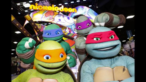The Teenage Mutant Ninja Turtles pose at the Nickelodeon booth on July 24.