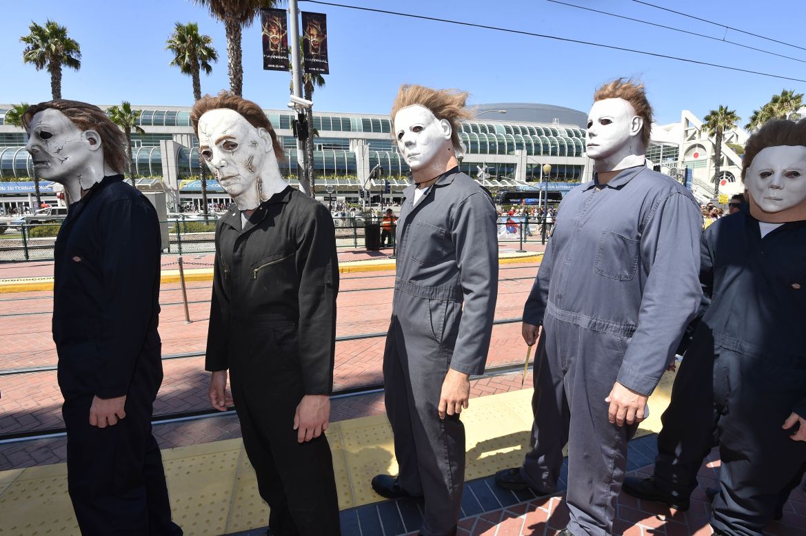 People dressed as Michael Myers from the "Halloween" films wait at a trolley stop outside of the San Diego Convention Center on July 24.