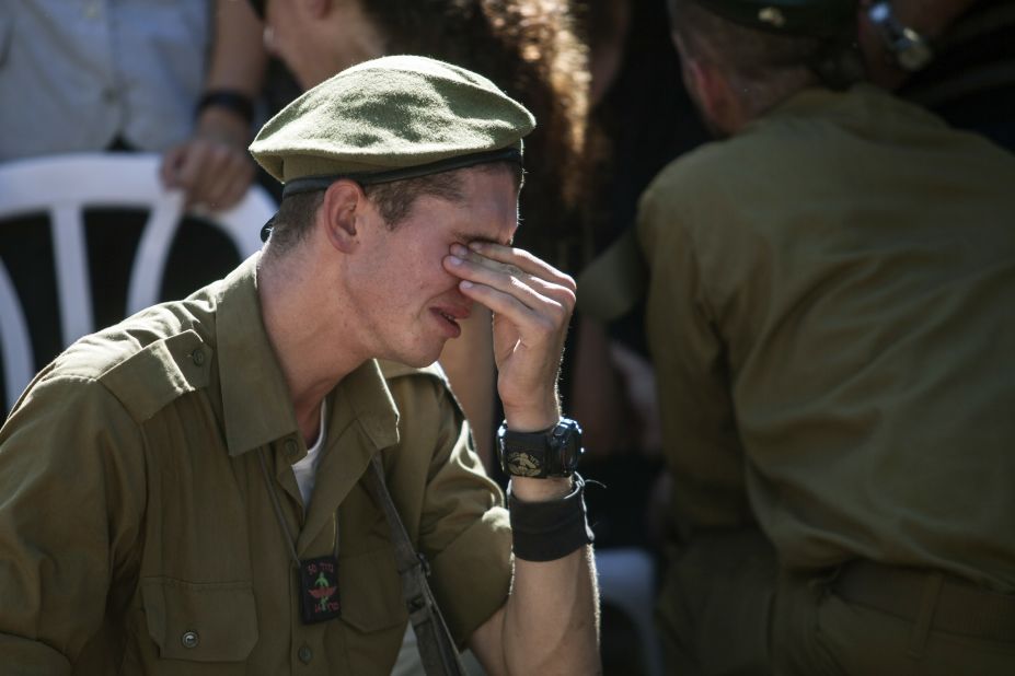 An Israeli soldier mourns at the grave of reserve Master Sgt. Yair Ashkenazy during his funeral at the military cemetery in Rehovot, Israel, on Friday, July 25. Ashkenazy was killed during operations in northern Gaza, the Israel Defense Forces reported.