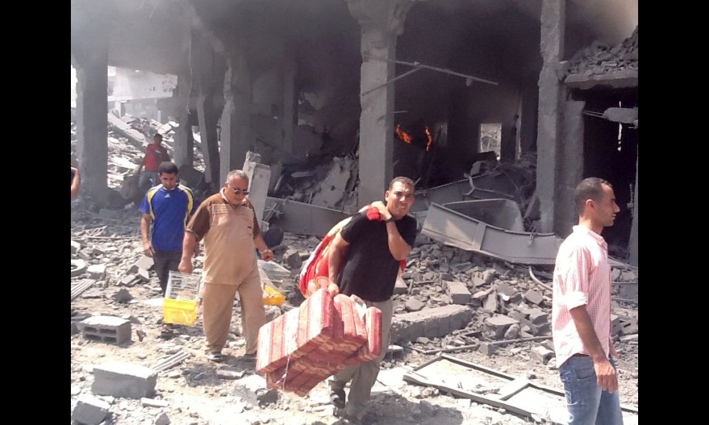 Residents return to the neighborhood in Gaza and sift through the rubble for their belongings. 