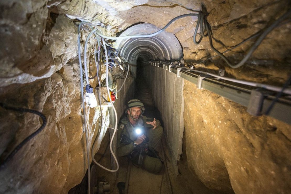 An Israeli army officer shows a tunnel Israel says was used by Palestinian militants for cross-border attacks.