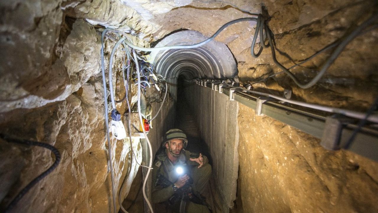 An Israeli army officer shows a tunnel Israel says was used by Palestinian militants for cross-border attacks.