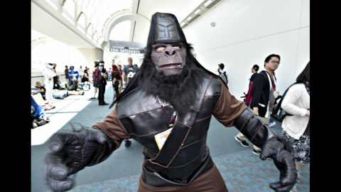 A fan dressed as a character from "Planet of the Apes" walks inside the convention center on July 26. 