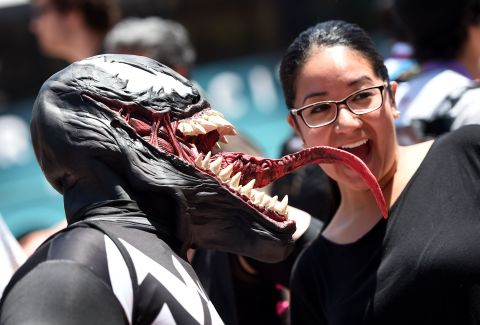 "Spiderman" villain Venom takes a taste of another attendee on July 26. 