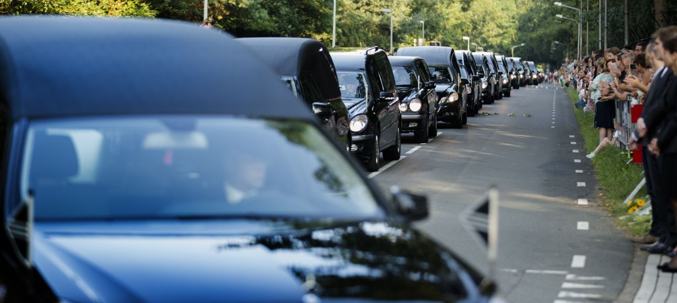 A line of hearses arrives at the Korporaal van Oudheusdenkazerne in Hilversum, Netherlands, on Saturday, July 26, as bodies from the crash of Malaysia Flight 17 are brought to the Netherlands where they will be identified. Flight 17 was shot down over Ukraine, killing all 298 people aboard. Of the people who died, 193 were Dutch citizens.
