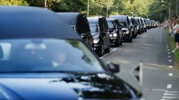 A line of hearses arrives at the Korporaal van Oudheusdenkazerne in Hilversum on Saturday, July 26, as bodies from the crash of Malaysia Flight 17 are brought to the Netherlands where they will be identified.