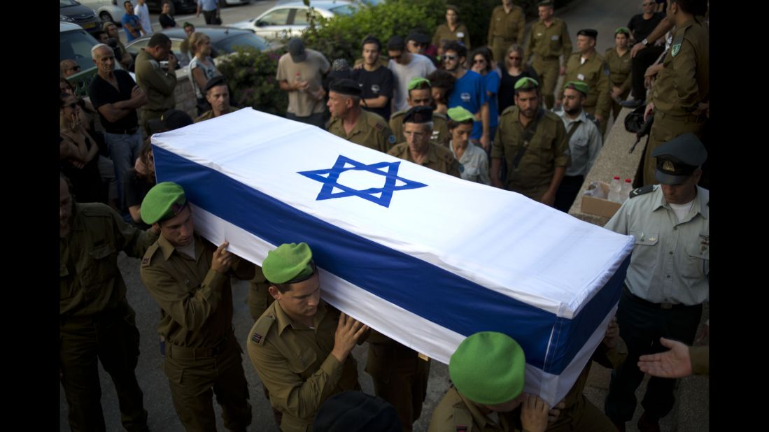 Israeli soldiers carry the coffin of 2nd Lt. Roy Peles, an infantry officer who was killed in combat, during his funeral in Tel Aviv on Sunday, July 27.