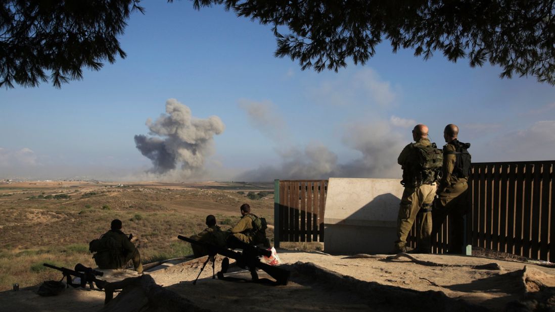 Israeli soldiers watch a bomb explode along the border with Gaza before the 12-hour cease-fire on July 26.