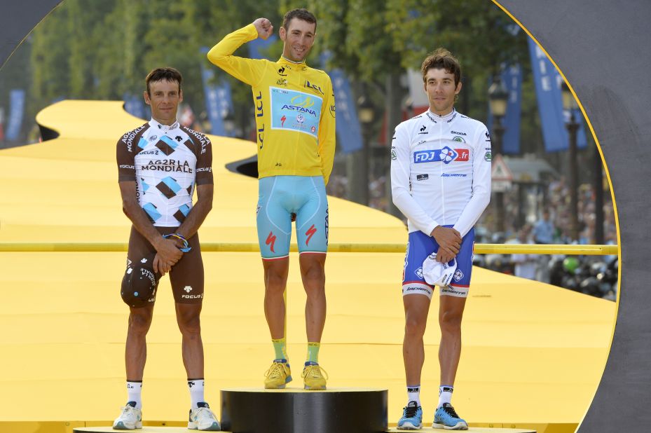 France's Jean-Christophe Peraud (left) and Thibaut Pinot flank winner Vincenzo Nibali of Italy on the podium for the 2014 Tour de France.