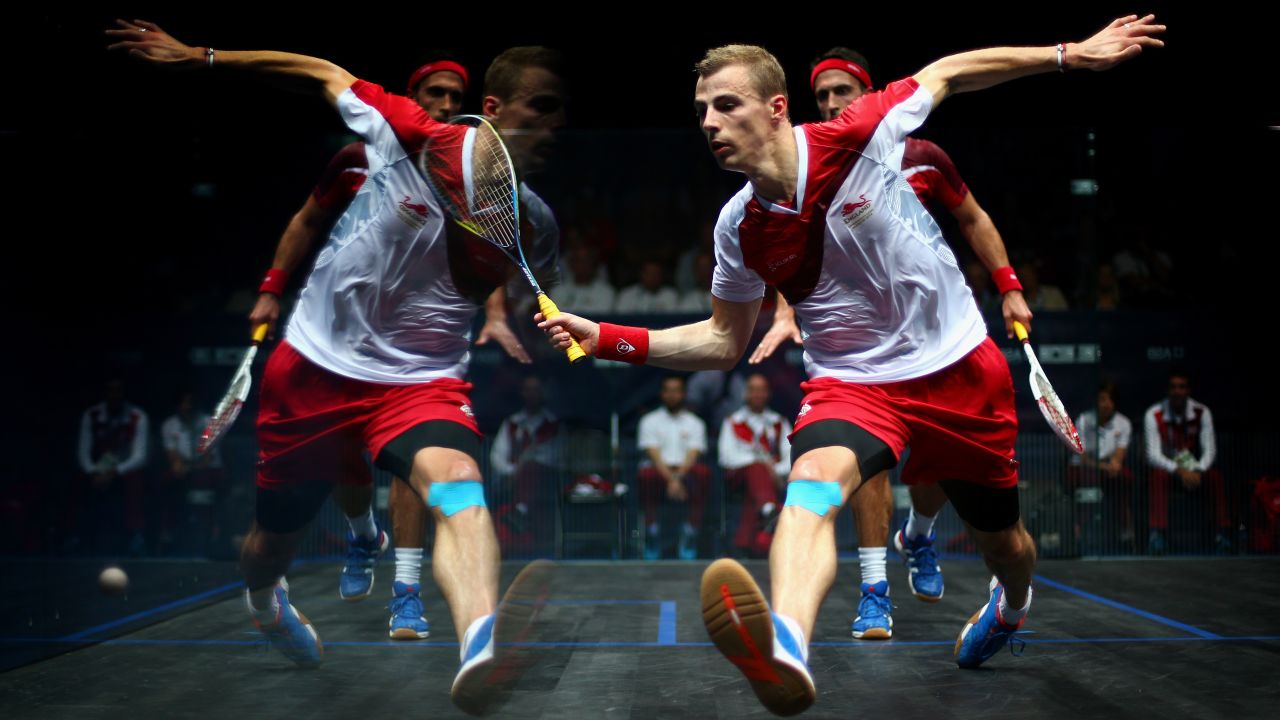 The reflection of squash player Nick Matthew is seen on the court's glass walls as he plays a shot against fellow Englishman Peter Barker in a semifinal match Sunday, July 27, at the Commonwealth Games in Glasgow, Scotland. Matthew advanced to the final, where he defeated another compatriot, James Willstrop, to win gold.