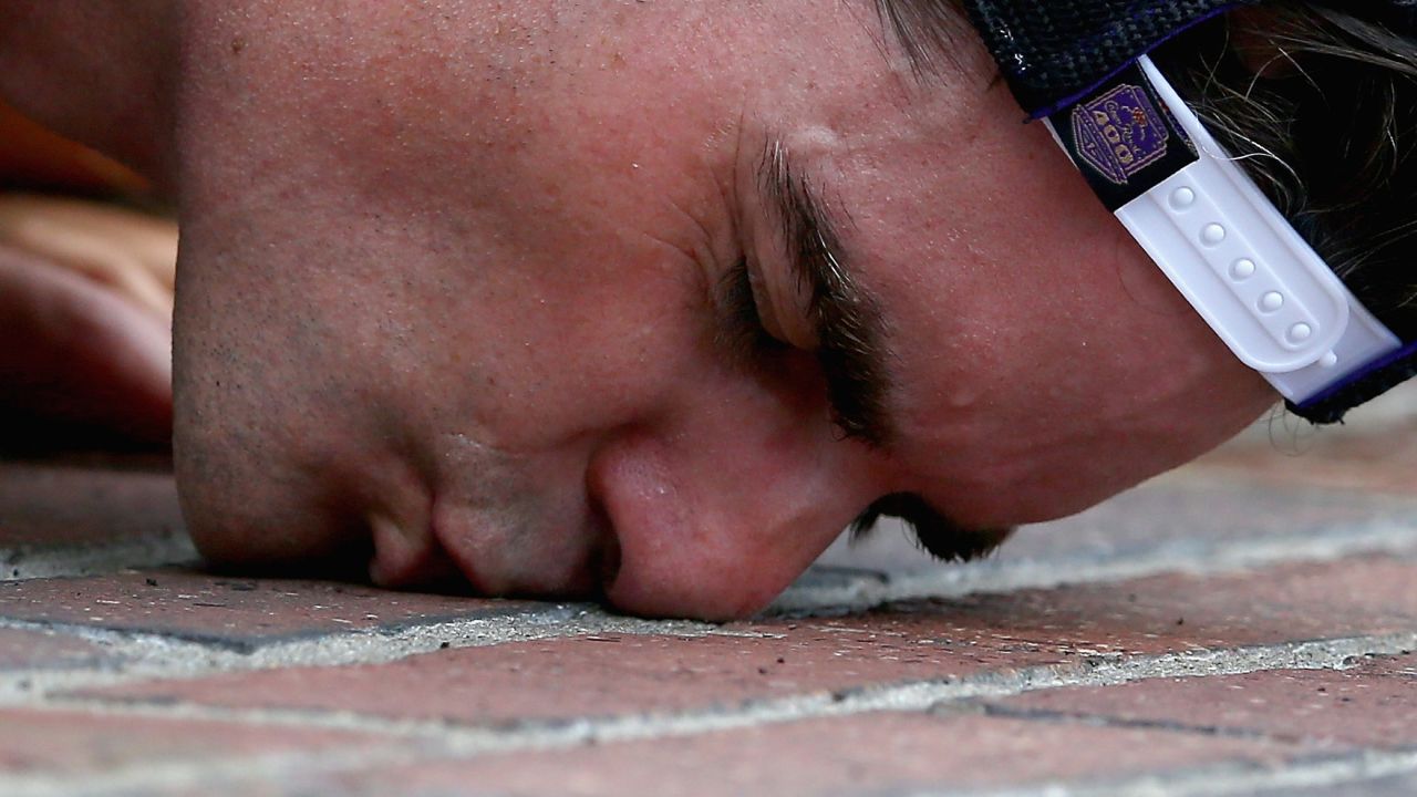 NASCAR driver Jeff Gordon celebrates a victory Sunday, July 27, by kissing the brick finish line at Indianapolis Motor Speedway. It was a NASCAR-record fifth win at the track for Gordon, who was raised in Indiana.