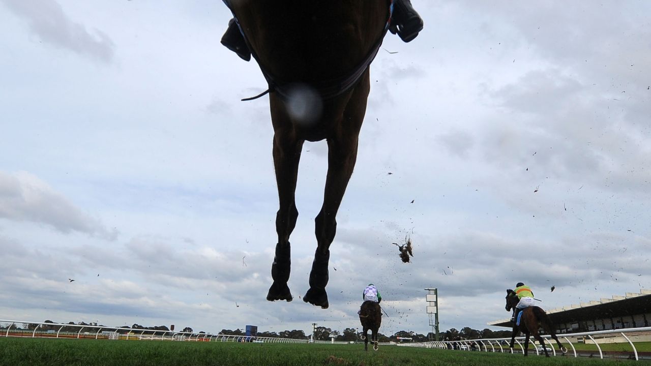 Horses race in the Grand National Steeplechase held Sunday, July 27, in Melbourne.