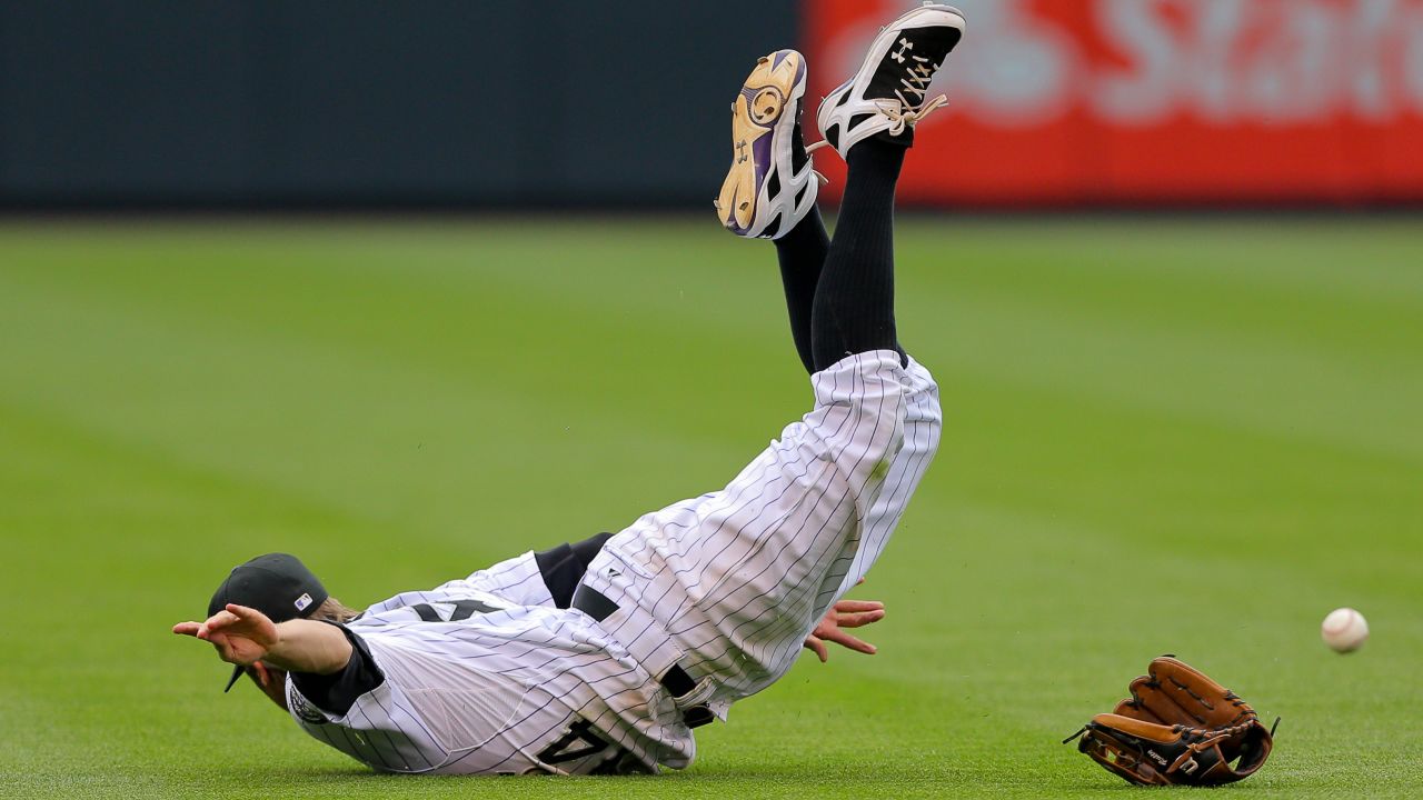 Colorado shortstop Josh Rutledge is unable to make a catch during a game in Denver on Sunday, July 27.