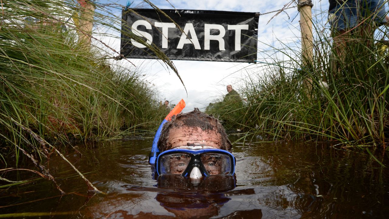 Stephen McDonagh takes part in the Irish Bog Snorkeling Championship held Sunday, July 27, at Peatlands Park in Dungannon, Northern Ireland. The annual event has male and female competitors swim the 60-meter length of the bog as they're watched by scores of spectators.