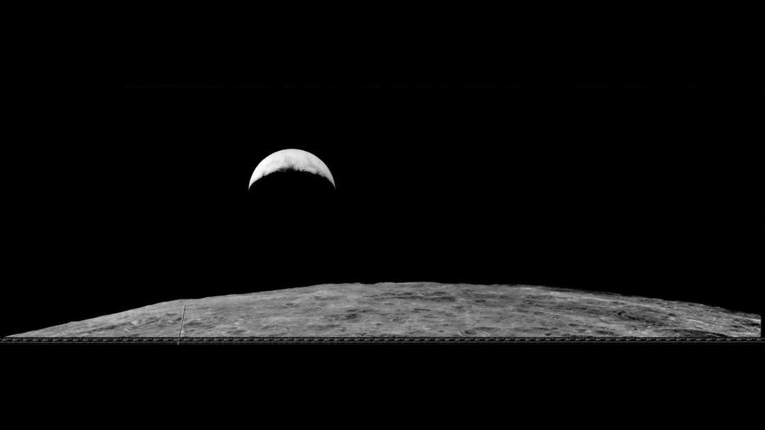 This second earthrise image was taken on August 25, 1966. Most of what is visible on the Moon's surface is the far side, with the Sea of Tsiolkovsky prominently featured.