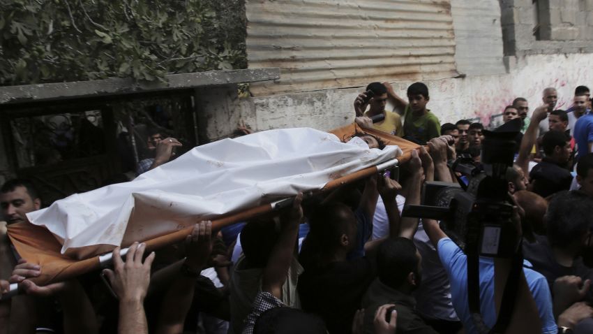 Palestinians carry the body of Gamal Ielian, 10, who was killed in an explosion at a park at the Shati refugee camp, in the northern Gaza Strip, Monday, July 28, 2014. Israeli and Palestinian authorities traded blame over the attack and fighting in the Gaza war raged on despite a major Muslim holiday.