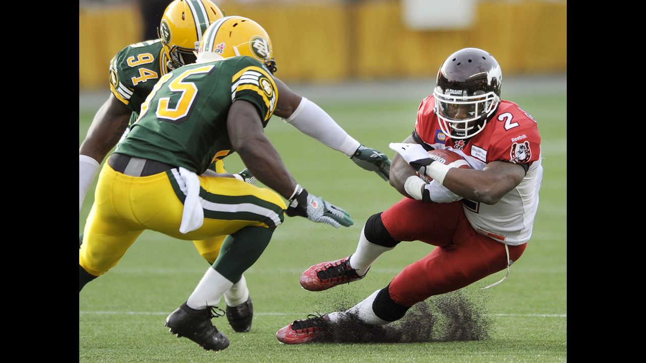 Jock Sanders of the Calgary Stampeders makes a cut to avoid Edmonton Eskimos Cameron Sheffield, left, and Gregory Alexandre during a Canadian Football League game in Edmonton on Thursday, July 24. Calgary won 26-22 to improve to 4-0 on the season.