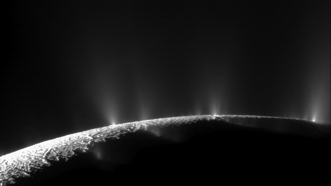 Plumes of water ice and vapor shoot up from the surface of Saturn's moon Enceladus in this two-image mosaic taken by Cassini in November 2009. Analysis by NASA scientists indicated that water can reach the Saturnian moon's surface.
