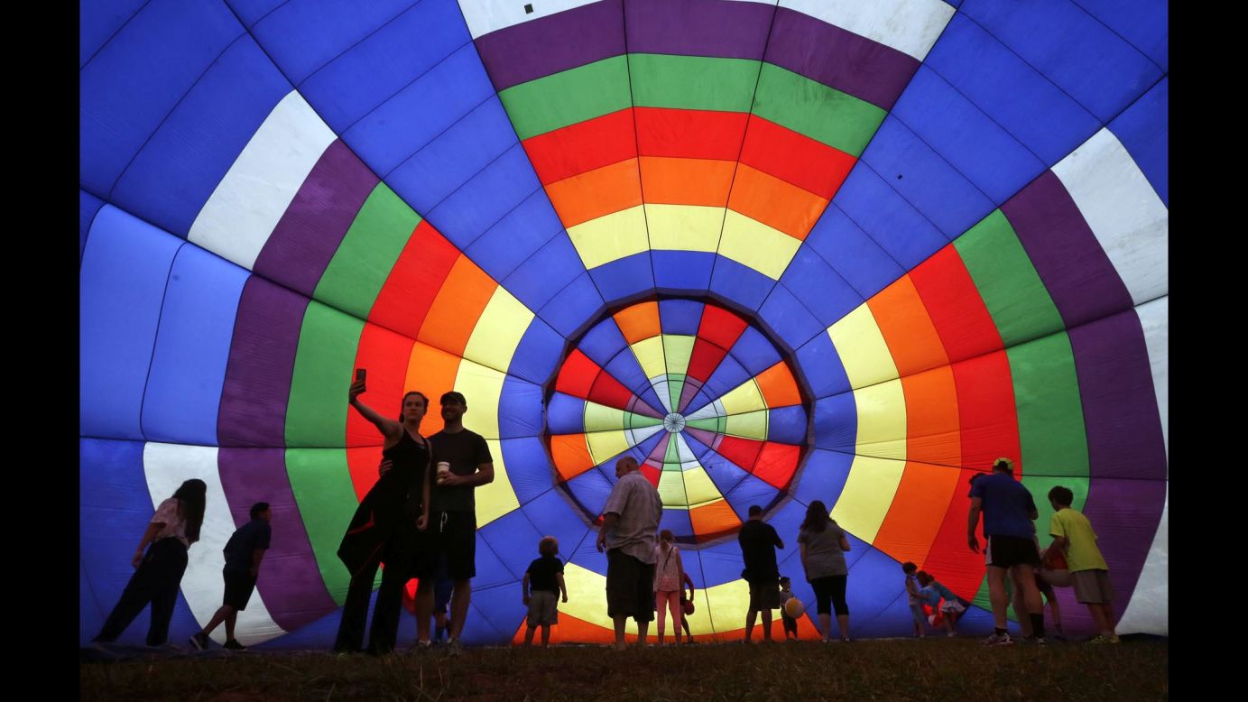 People walk around a partially inflated hot-air balloon Sunday, July 27, at the 32nd annual New Jersey Festival of Ballooning in Readington, New Jersey.