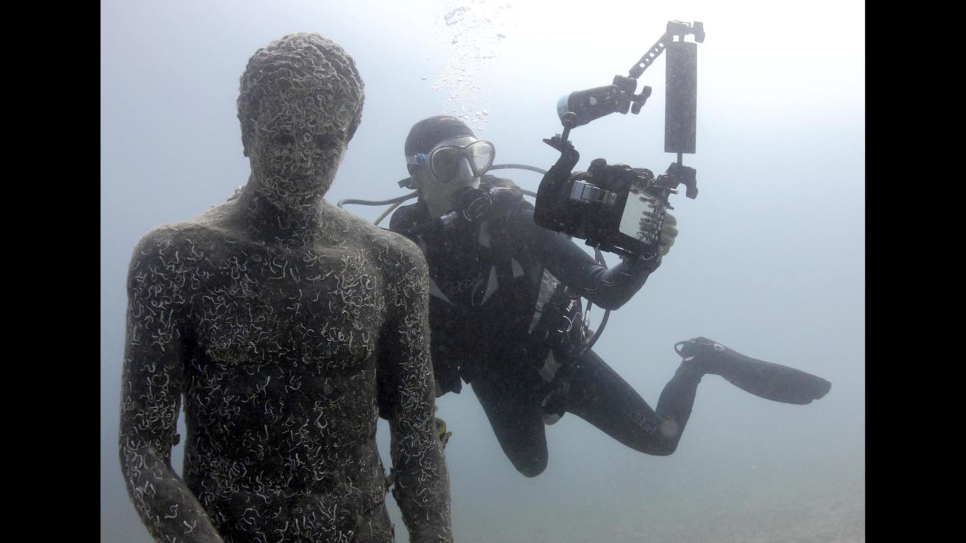 A diver takes a selfie with a replica Greek sculpture Thursday, July 24, at the Historical Underwater Park in Mali Losinj, Croatia.