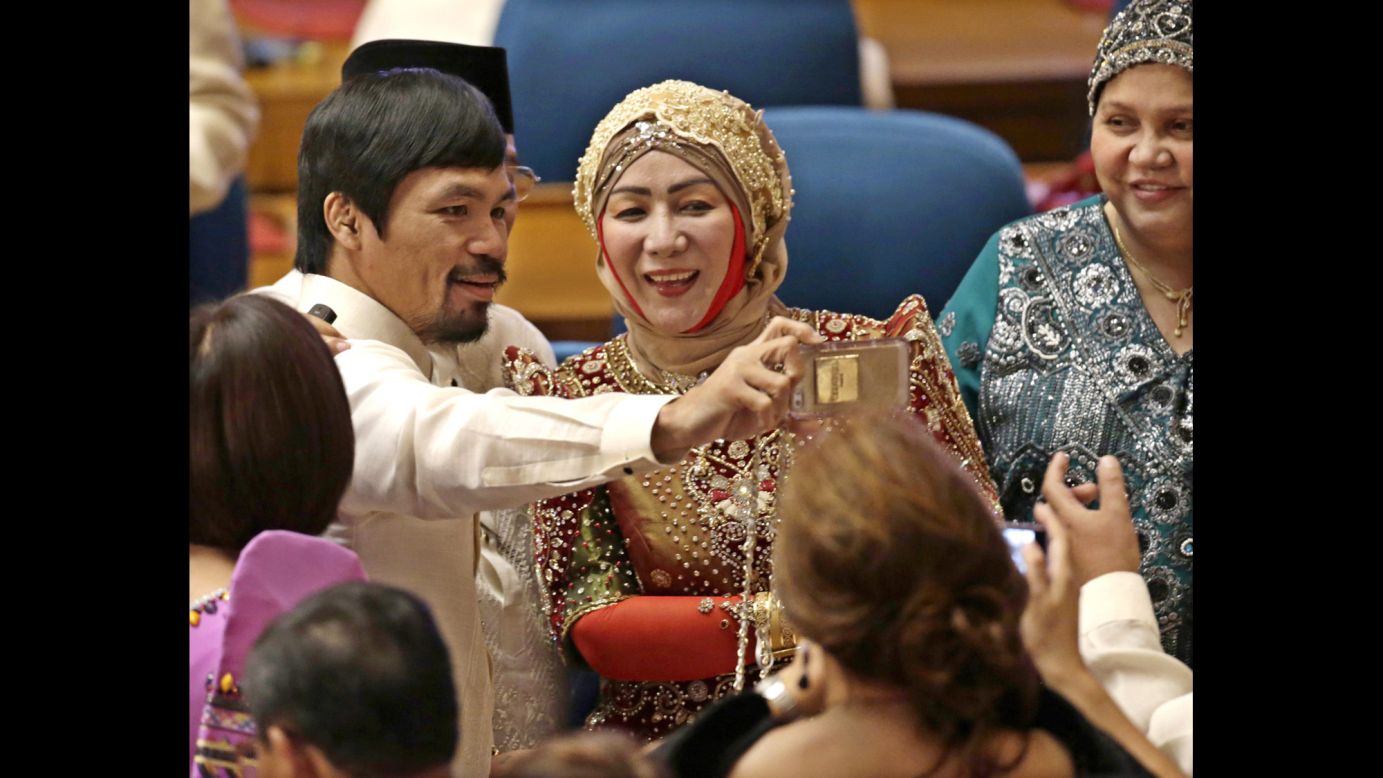Boxing champion Manny Pacquiao takes a selfie with fellow Philippine lawmakers before a joint session of Congress on Monday, July 28, in Manila, Philippines. Pacquiao was elected to the Philippine House of Representatives in 2010.