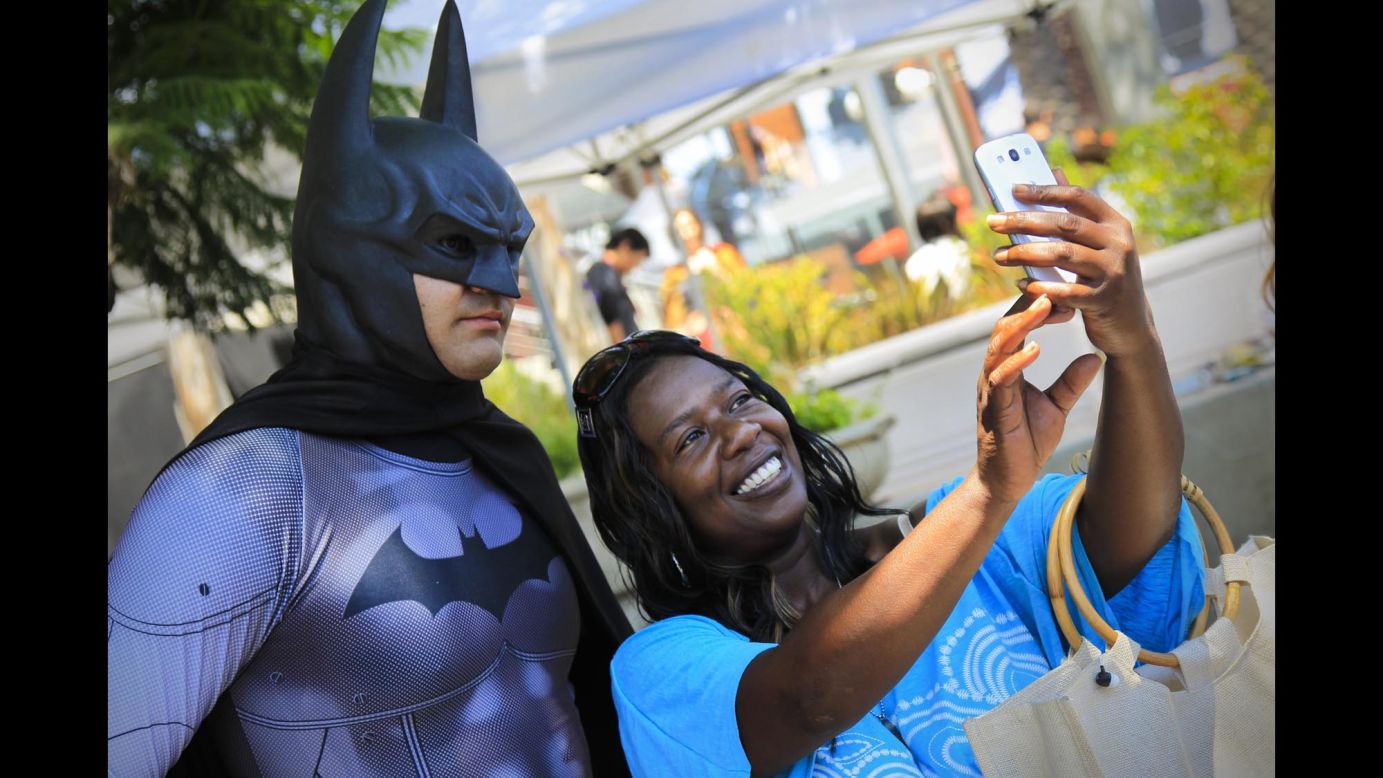 Yozan Brown takes a selfie with Batman at Comic-Con on Thursday, July 24.