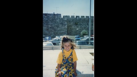 Naim Naif's second oldest sister, Atheer, sits in front of the wall of the old city in Jerusalem in 1998. 