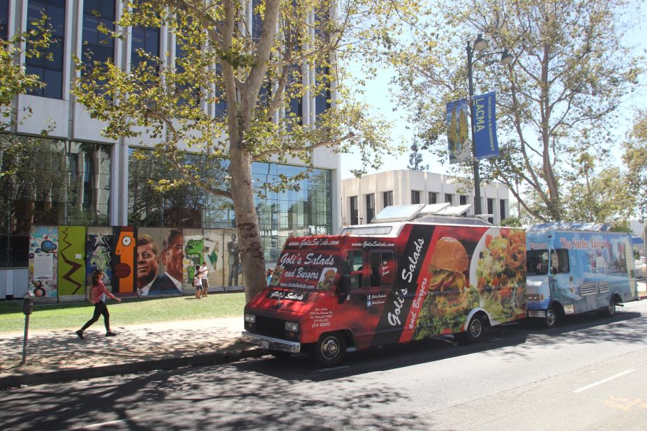 Food trucks often congregate near 5900 Wilshire Boulevard, where the largest stretch of the Berlin Wall (background) outside of Germany is on public display. The Los Angeles County Museum of Art is across the street.