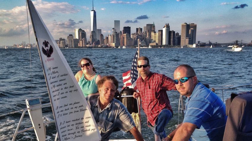 Maire Kent's sister, Nora Kent, producer Keith Famie and brothers Breandan and Geoff Kent pose with Maire's boat in the New York Harbor.