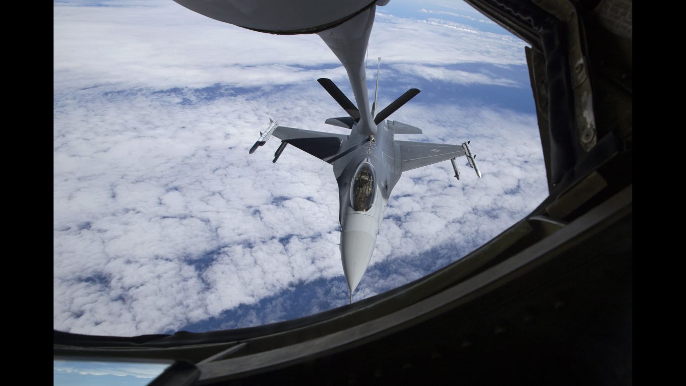 An American F-16 jet moves into position beneath a KC-135 "Stratotanker" for a refueling mission July 23, in the airspace west of Hawaii.