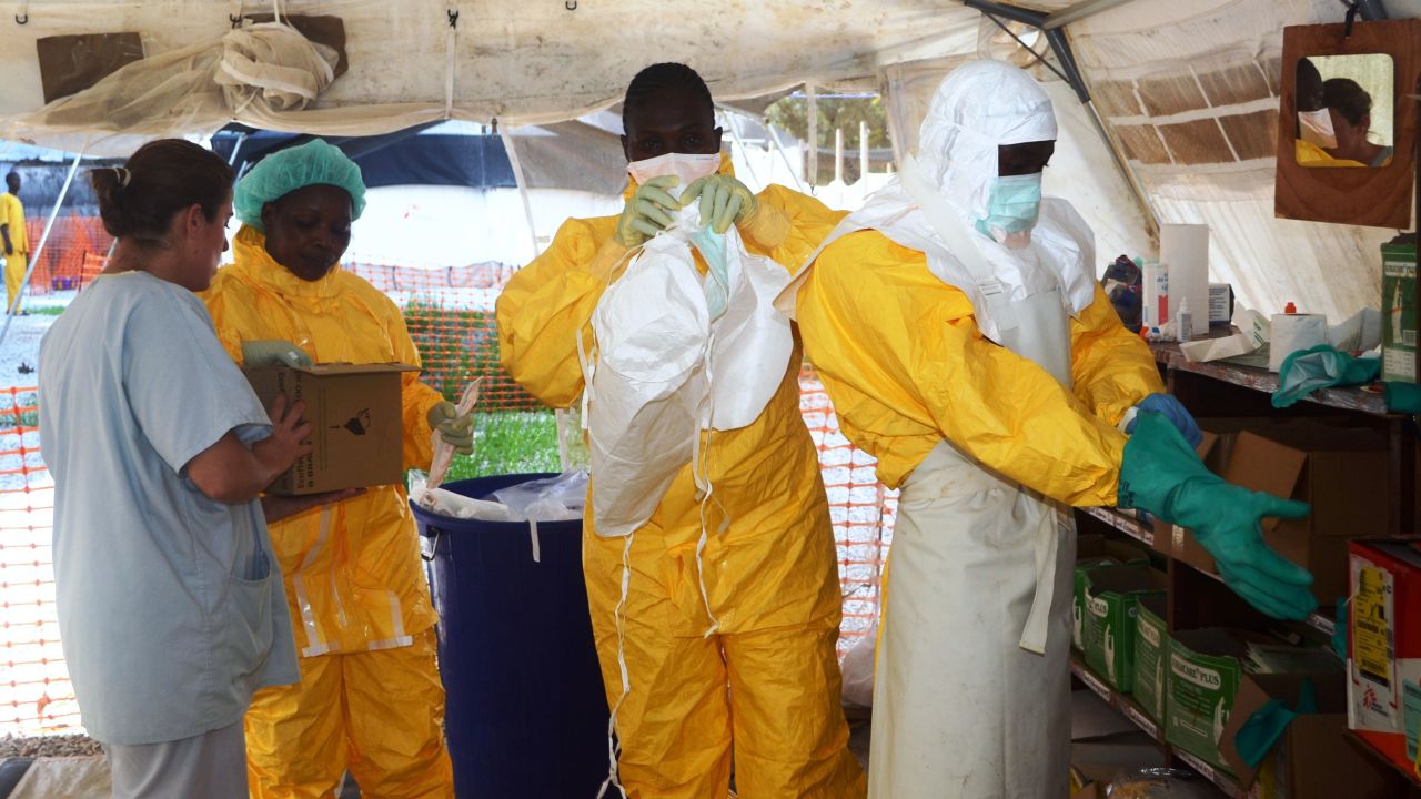 A picture taken on June 28, 2014 shows members of Doctors Without Borders (MSF) putting on protective gear at the isolation ward of the Donka Hospital in Conakry, where people infected with the Ebola virus are being treated. The World Health Organization has warned that Ebola could spread beyond hard-hit Guinea, Liberia and Sierra Leone to neighbouring nations, but insisted that travel bans were not the answer. To date, there have been 635 cases of haemorrhagic fever in Guinea, Liberia and Sierra Leone, most confirmed as Ebola. A total of 399 people have died, 280 of them in Guinea.