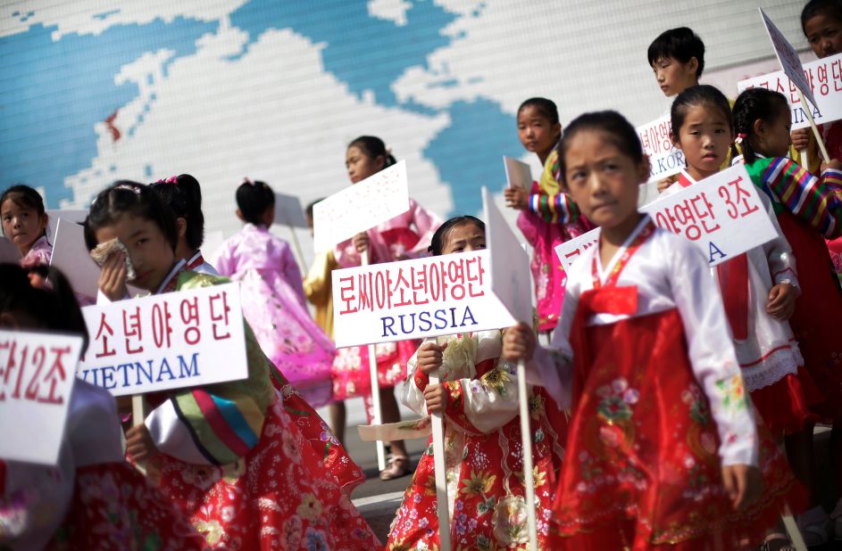 North Korean girls welcome students from participating countries during an opening ceremony at the Songdowon International Children's Camp on July 29, 2014. 